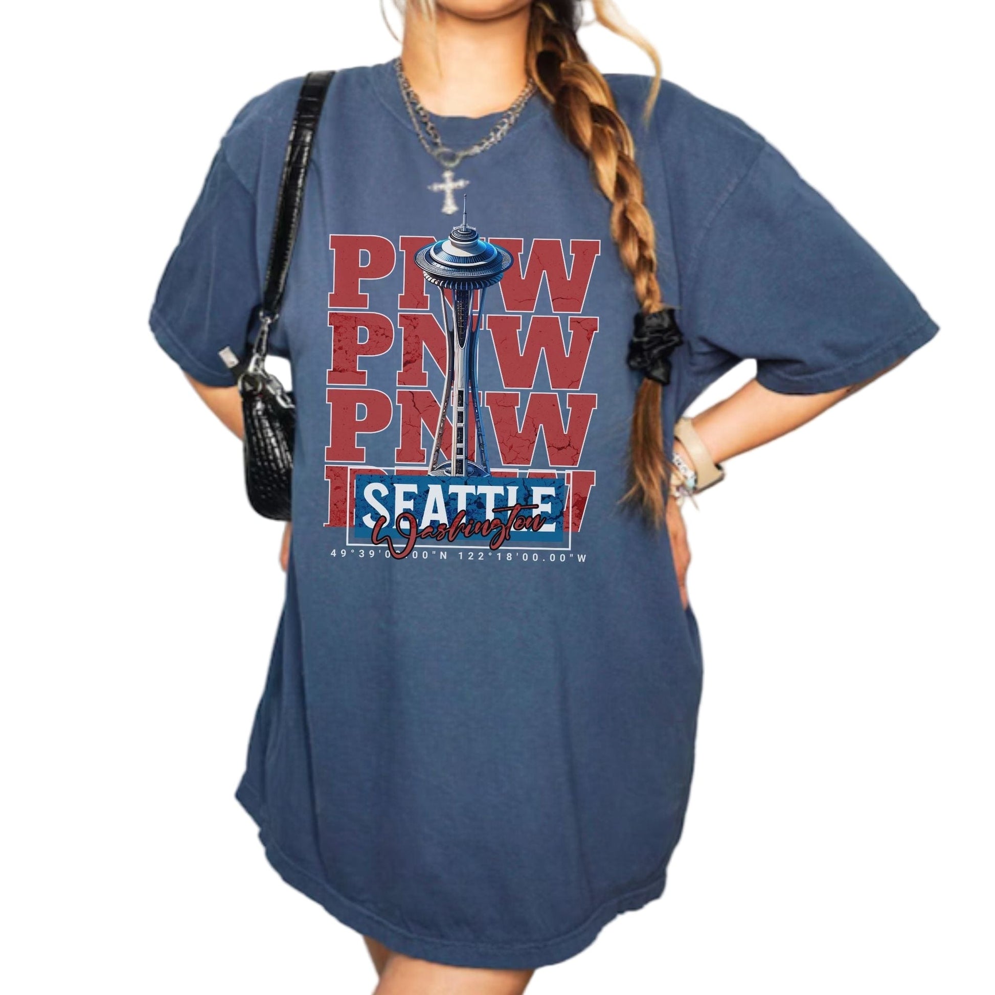 Person wearing a blue t-shirt with 'Paw Paw Seattle' design on a plain background